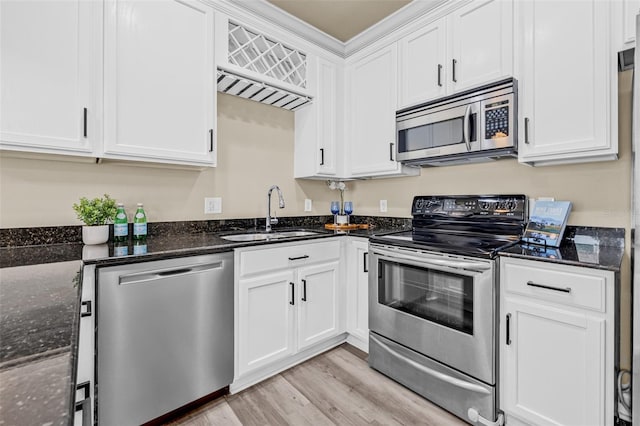 215 S Westland Ave Unit 3, Tampa, FL 33606 - kitchen with appliances with stainless steel finishes, a sink, light wood-type flooring, and white cabinets