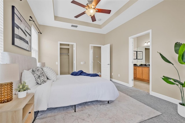 215 S Westland Ave Unit 3, Tampa, FL 33606 - bedroom featuring light colored carpet, a raised ceiling, baseboards, ensuite bath, and a spacious closet