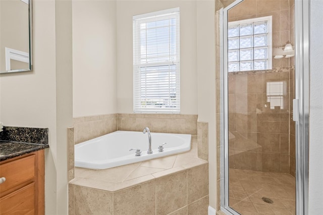 215 S Westland Ave Unit 3, Tampa, FL 33606 - bathroom featuring vanity, healthy amount of natural light, a bath, and a shower stall