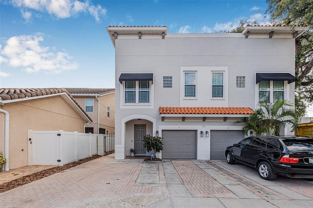 215 S Westland Ave Unit 3, Tampa, FL 33606 - mediterranean / spanish-style home featuring stucco siding, decorative driveway, a tile roof, and an attached garage