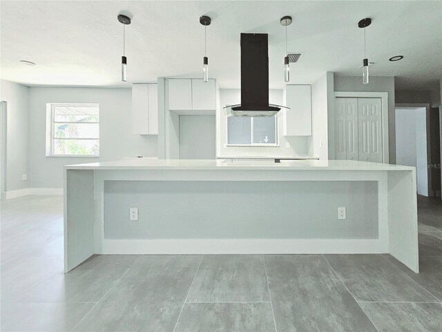 20295 Lorenzo Ave, Port Charlotte, FL 33952 - kitchen featuring island range hood, white cabinetry, modern cabinets, light countertops, and a spacious island