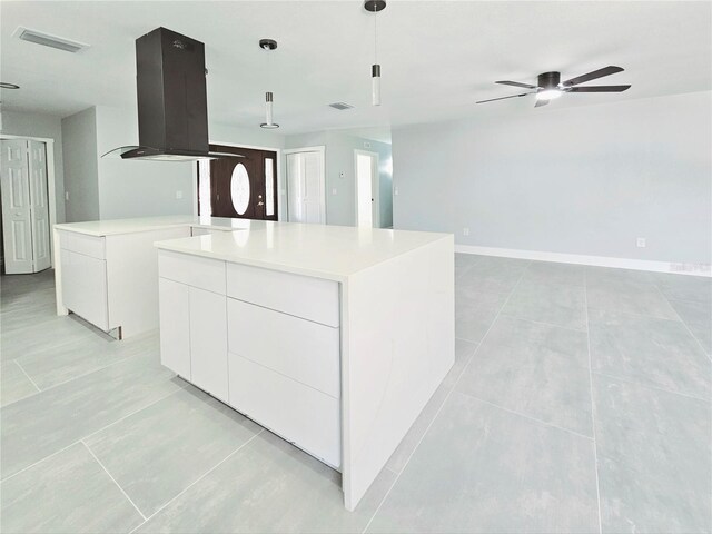 20295 Lorenzo Ave, Port Charlotte, FL 33952 - kitchen with exhaust hood, modern cabinets, a center island, a ceiling fan, and white cabinetry