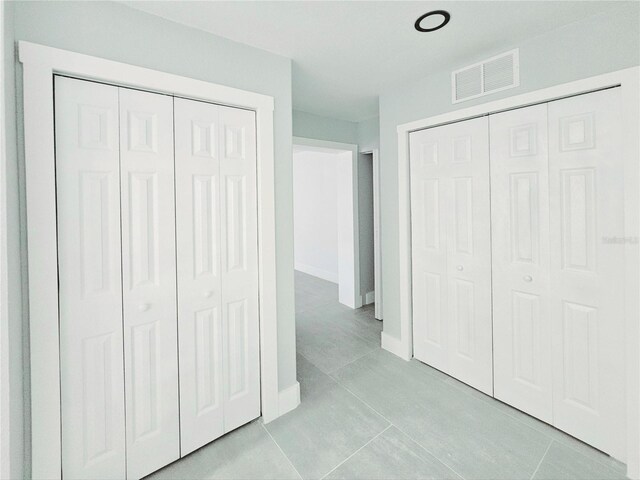 20295 Lorenzo Ave, Port Charlotte, FL 33952 - unfurnished bedroom featuring baseboards and light tile patterned floors