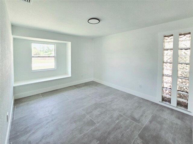 20295 Lorenzo Ave, Port Charlotte, FL 33952 - unfurnished room with tile patterned floors and baseboards