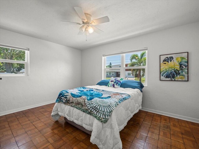 4005 W Coachman Ave, Tampa, FL 33611 - bedroom with baseboards and ceiling fan
