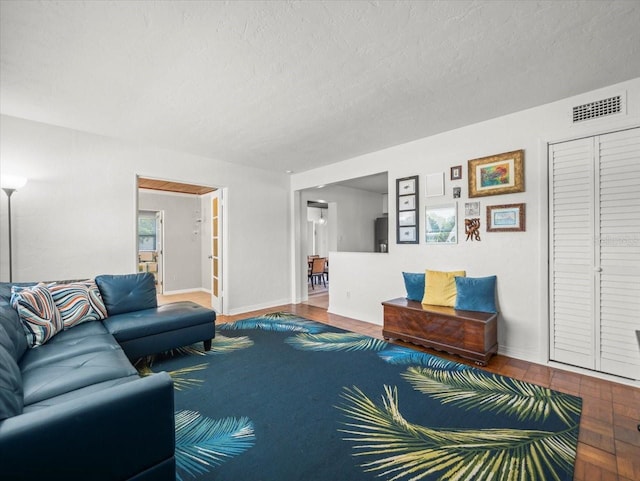 4005 W Coachman Ave, Tampa, FL 33611 - living area with a textured ceiling, baseboards, and wood finished floors