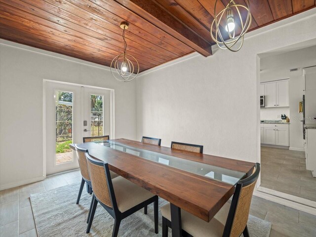 4005 W Coachman Ave, Tampa, FL 33611 - dining space with a chandelier, wood ceiling, light tile patterned floors, and french doors