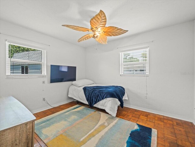 4005 W Coachman Ave, Tampa, FL 33611 - bedroom featuring baseboards and a ceiling fan