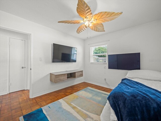 4005 W Coachman Ave, Tampa, FL 33611 - bedroom with baseboards and ceiling fan