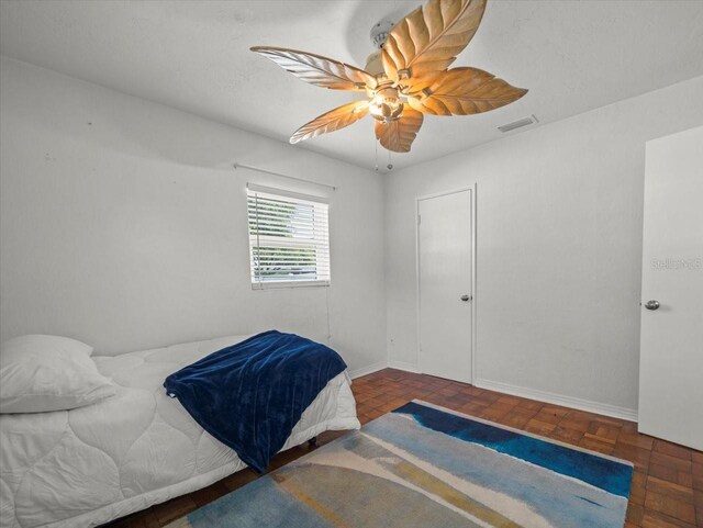 4005 W Coachman Ave, Tampa, FL 33611 - bedroom with a ceiling fan and baseboards