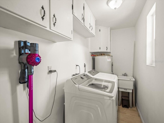4005 W Coachman Ave, Tampa, FL 33611 - washroom featuring washer and dryer, electric water heater, cabinet space, and baseboards