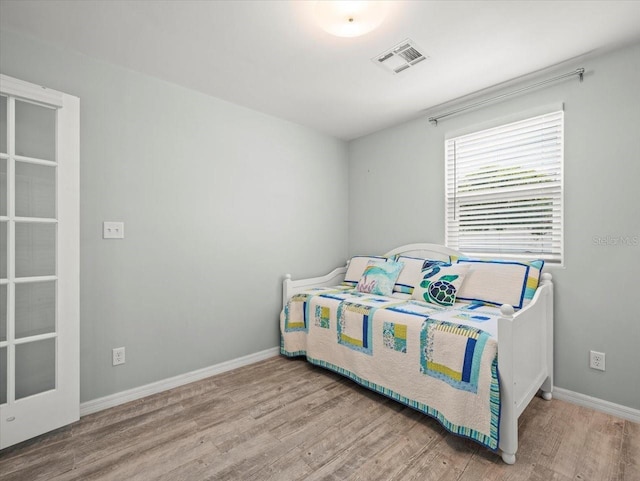 4005 W Coachman Ave, Tampa, FL 33611 - bedroom with wood finished floors and baseboards