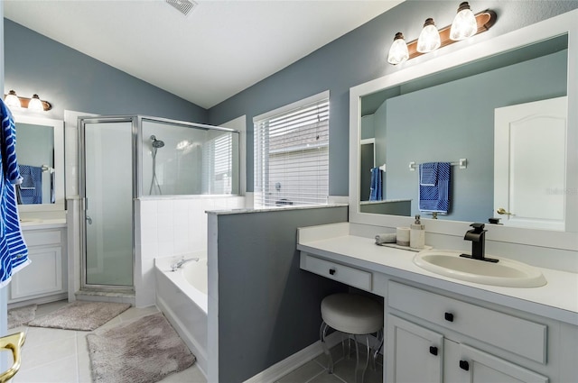 10811 Lakeside Vista Dr, Riverview, FL 33569 - full bathroom featuring a shower stall, a garden tub, vanity, vaulted ceiling, and tile patterned floors