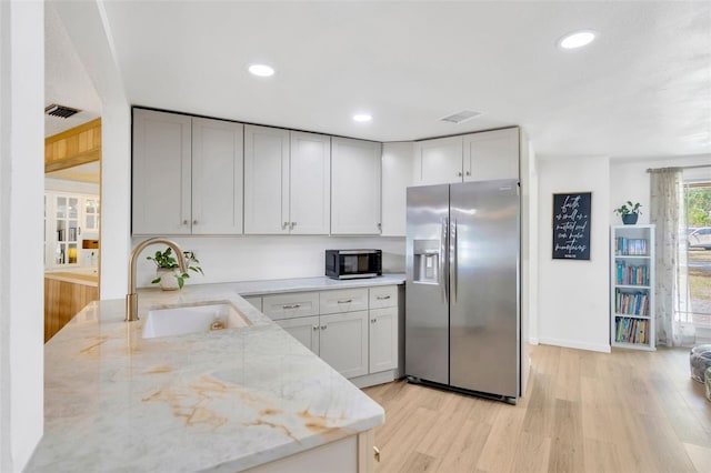 525 Gornto Lake Rd, Brandon, FL 33510 - kitchen with stainless steel refrigerator with ice dispenser, a sink, light wood-style flooring, light stone countertops, and recessed lighting