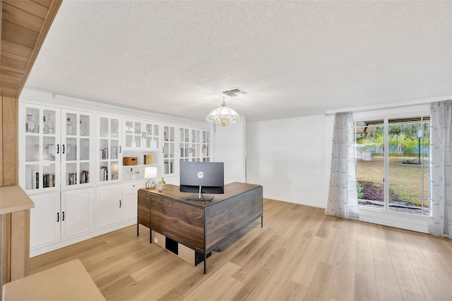525 Gornto Lake Rd, Brandon, FL 33510 - home office featuring light wood-type flooring, a chandelier, a textured ceiling, and baseboards