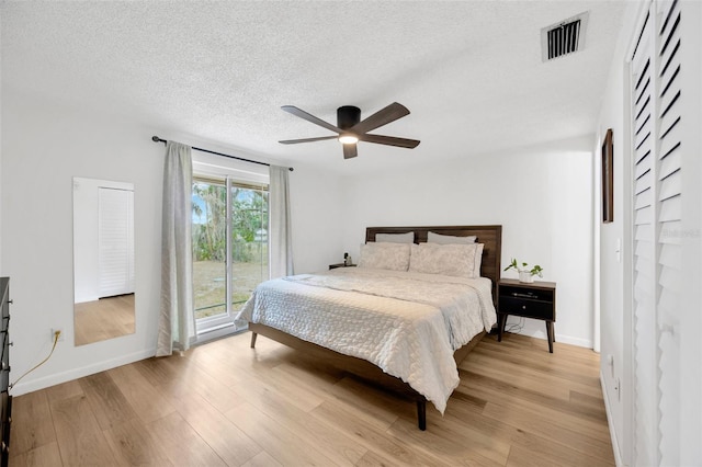 525 Gornto Lake Rd, Brandon, FL 33510 - bedroom featuring access to exterior, light wood finished floors, baseboards, a textured ceiling, and ceiling fan