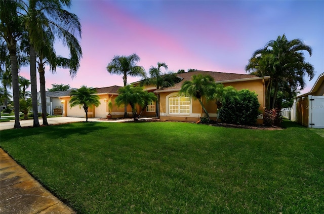 13028 Prestwick Dr, Riverview, FL 33579 - view of front of home with concrete driveway, an attached garage, a lawn, and stucco siding