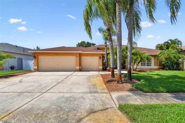 13028 Prestwick Dr, Riverview, FL 33579 - ranch-style house featuring stucco siding, a garage, concrete driveway, and a front lawn