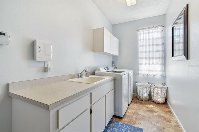 13028 Prestwick Dr, Riverview, FL 33579 - laundry room featuring washer and clothes dryer, cabinet space, baseboards, and a textured ceiling