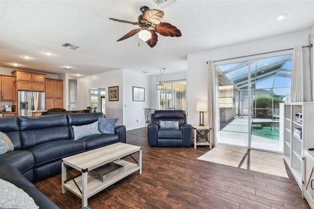 13028 Prestwick Dr, Riverview, FL 33579 - living room with a ceiling fan, a textured ceiling, dark wood-style floors, baseboards, and recessed lighting