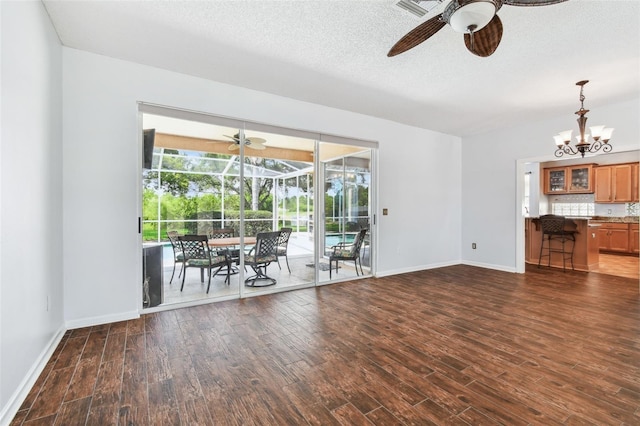 13028 Prestwick Dr, Riverview, FL 33579 - unfurnished living room featuring a ceiling fan, wood finished floors, baseboards, and a textured ceiling