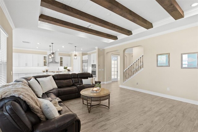 6154 Marsh Trail Dr, Odessa, FL 33556 - living area with beamed ceiling, light wood-style flooring, stairway, arched walkways, and recessed lighting