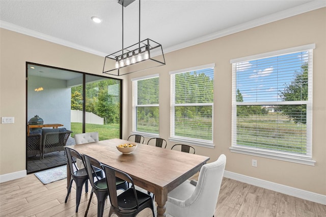 6154 Marsh Trail Dr, Odessa, FL 33556 - dining space with crown molding, light wood-type flooring, baseboards, and a chandelier