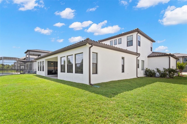6154 Marsh Trail Dr, Odessa, FL 33556 - back of house with a yard, stucco siding, and a tiled roof