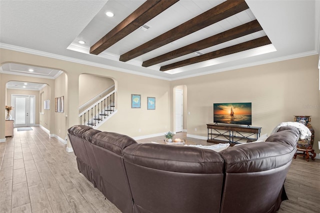 6154 Marsh Trail Dr, Odessa, FL 33556 - living room featuring arched walkways, stairway, light wood finished floors, baseboards, and beamed ceiling