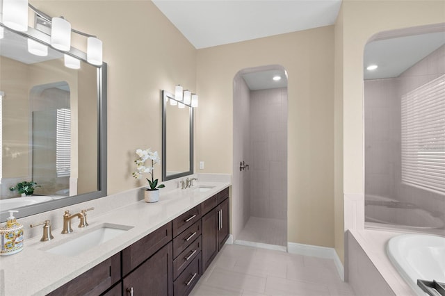 6154 Marsh Trail Dr, Odessa, FL 33556 - full bathroom with a garden tub, double vanity, tile patterned floors, walk in shower, and baseboards