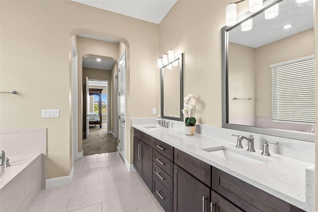 6154 Marsh Trail Dr, Odessa, FL 33556 - full bath featuring double vanity, a garden tub, connected bathroom, baseboards, and tile patterned flooring