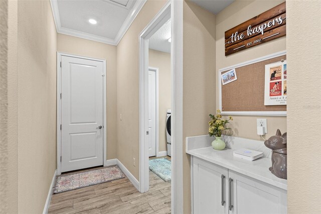 6154 Marsh Trail Dr, Odessa, FL 33556 - hall with light wood-style floors, ornamental molding, baseboards, and washer / dryer