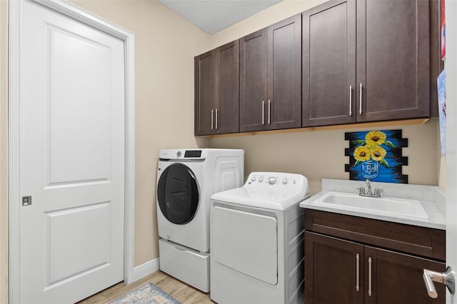 6154 Marsh Trail Dr, Odessa, FL 33556 - washroom with separate washer and dryer, cabinet space, light wood-type flooring, and baseboards