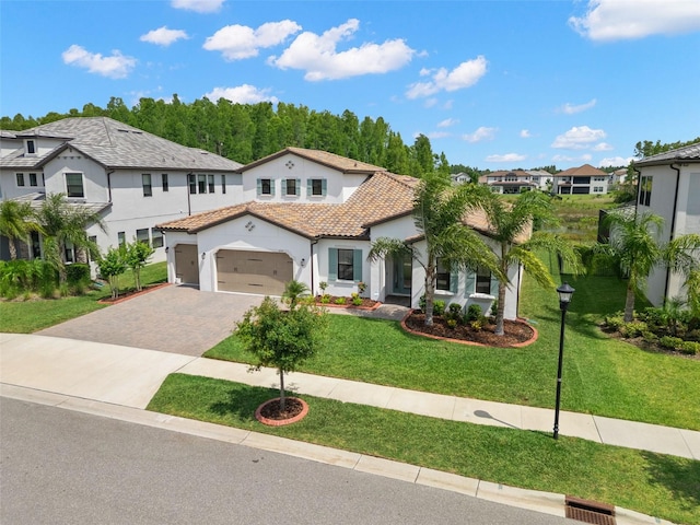 6154 Marsh Trail Dr, Odessa, FL 33556 - mediterranean / spanish home with driveway, a tile roof, stucco siding, a residential view, and a front yard