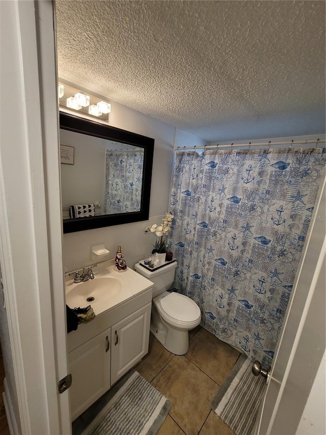 bathroom featuring a textured ceiling, tile patterned flooring, toilet, vanity, and a shower with curtain