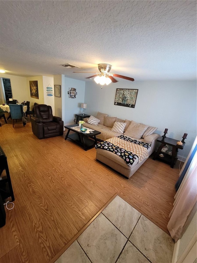 living room featuring a textured ceiling and wood finished floors