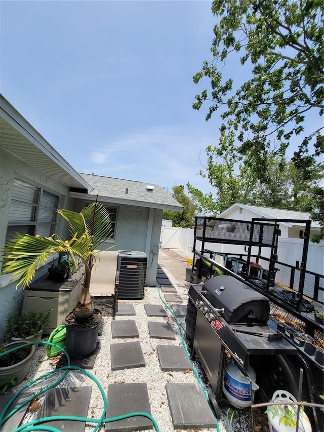 fenced backyard with central AC unit and a patio area