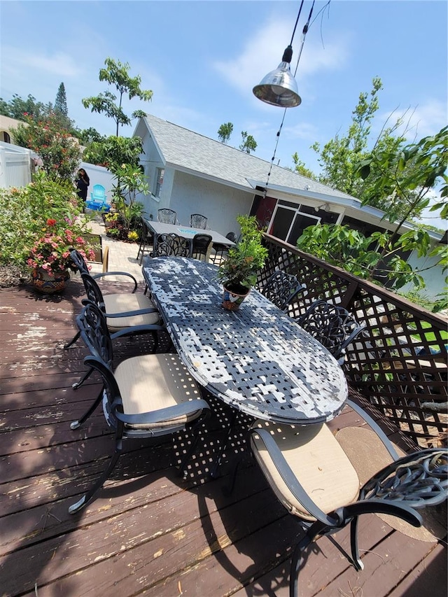 wooden terrace with outdoor dining area
