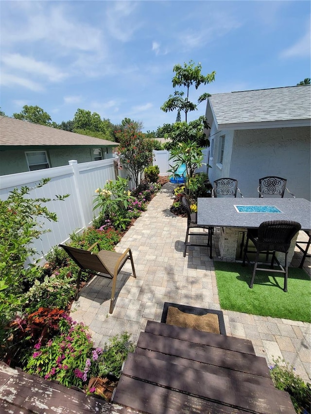 fenced backyard with outdoor dining area and a patio area