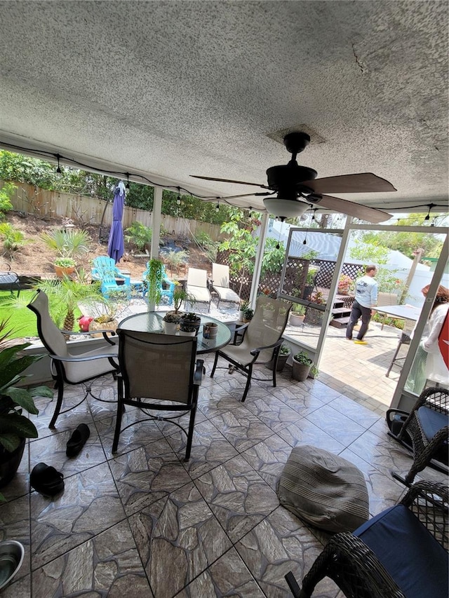 fenced backyard with outdoor dining space, a patio area, and ceiling fan