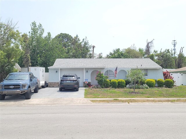ranch-style home with a garage and concrete driveway