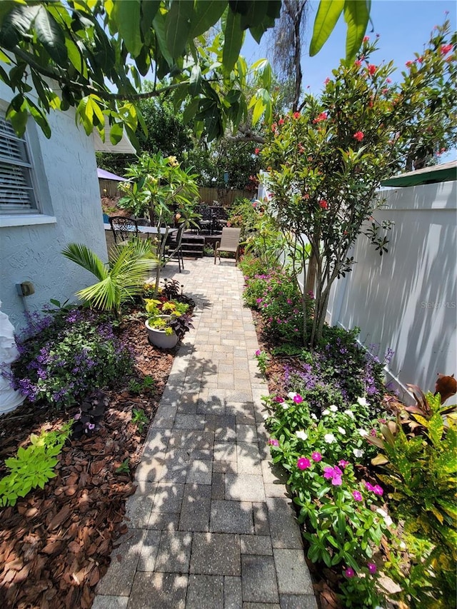 view of community with a fenced backyard and a patio area