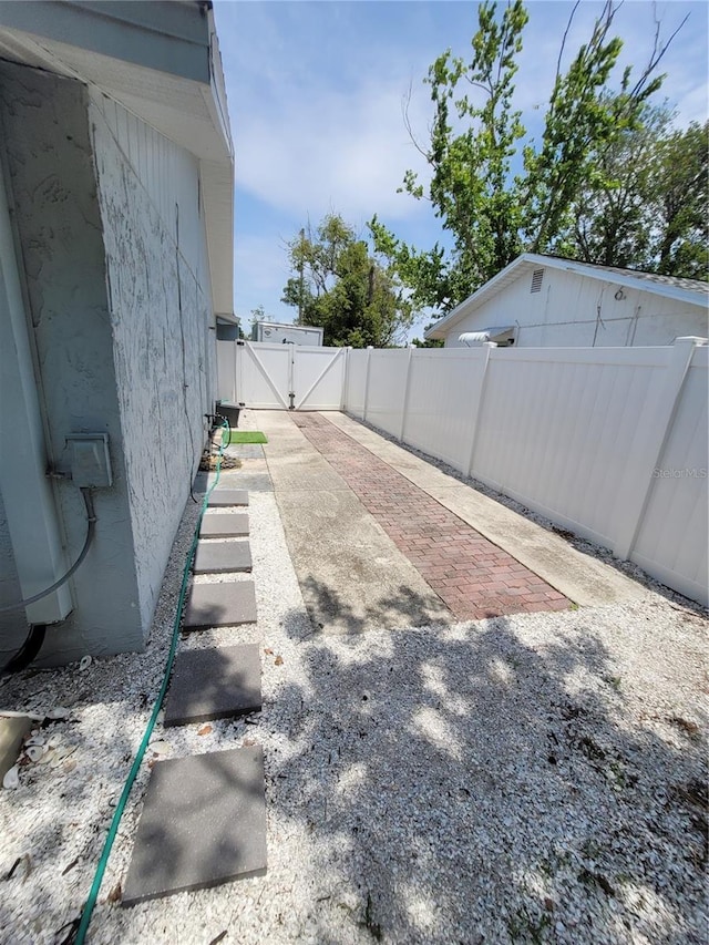 6318 Ridge Crest Dr, Port Richey, FL 34668 - fenced backyard featuring a gate and a patio