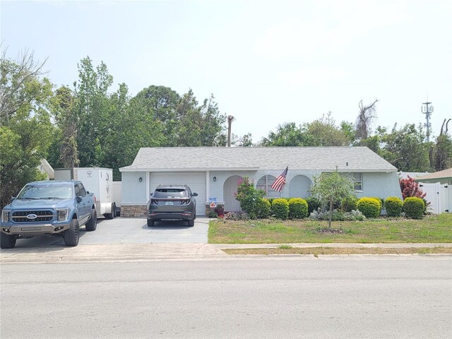 6318 Ridge Crest Dr, Port Richey, FL 34668 - ranch-style home featuring driveway and an attached garage