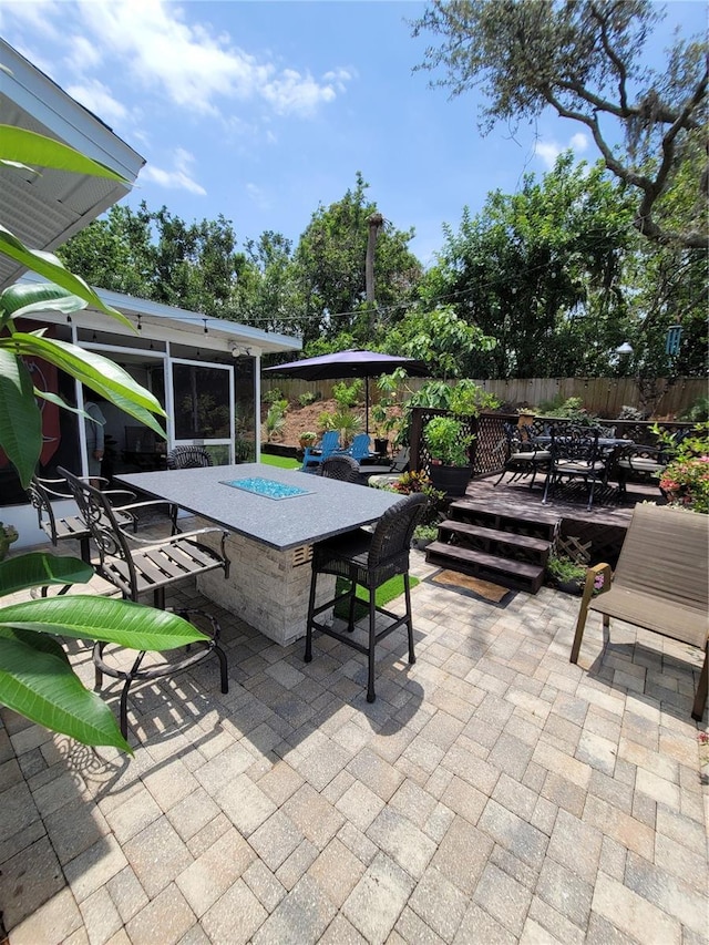 6318 Ridge Crest Dr, Port Richey, FL 34668 - view of patio featuring a deck and a sunroom