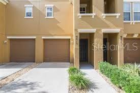 9013 White Sage Loop, Lakewood Ranch, FL 34202 - townhome / multi-family property with stucco siding, an attached garage, and driveway