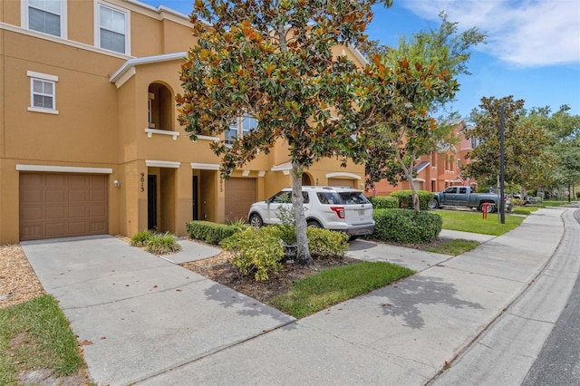 9013 White Sage Loop, Lakewood Ranch, FL 34202 - view of front of house with stucco siding, concrete driveway, and a garage