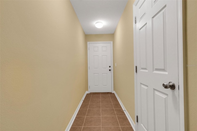 9013 White Sage Loop, Lakewood Ranch, FL 34202 - corridor with dark tile patterned floors and baseboards