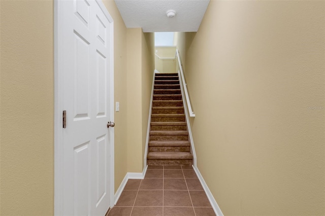 9013 White Sage Loop, Lakewood Ranch, FL 34202 - stairs with tile patterned floors, a textured ceiling, and baseboards