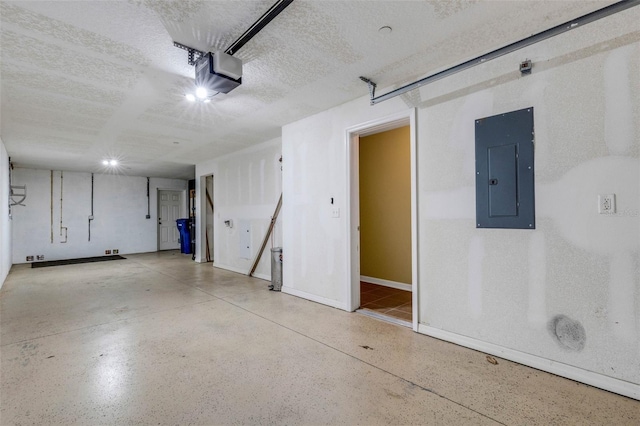 9013 White Sage Loop, Lakewood Ranch, FL 34202 - garage featuring electric panel, a garage door opener, and baseboards
